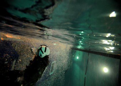 US Navy 110210-N-1810F-075 A student swims to the surface after exiting the 9D6 dunker during a simulated aircraft water landing exercise at the Av