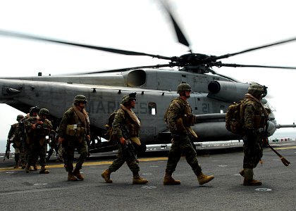 US Navy 110213-N-8607R-075 Marines assigned to the 31st Marine Expeditionary Unit (31st MEU) debark from a CH-53E Sea Stallion helicopter aboard th photo
