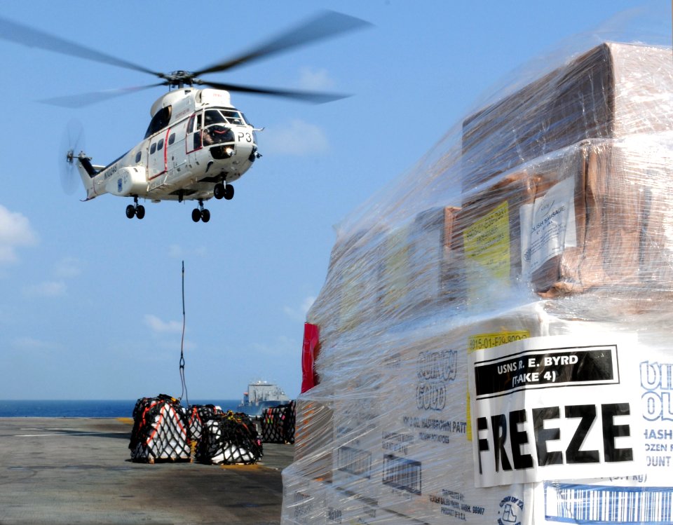 US Navy 110215-N-5538K-101 An SA-330J Puma helicopter places supplies on the flight deck of the amphibious assault ship USS Essex (LHD 2) during a