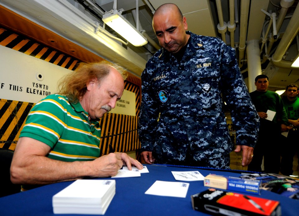 US Navy 110211-N-8040H-014 Stand-up comedian Gallagher signs an autograph for Chief Yeoman Martiano Magana on the mess decks aboard the Nimitz-clas