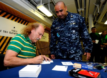 US Navy 110211-N-8040H-014 Stand-up comedian Gallagher signs an autograph for Chief Yeoman Martiano Magana on the mess decks aboard the Nimitz-clas