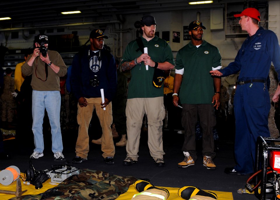 US Navy 110214-N-2908M-074 Super Bowl XLV champions, the Green Bay Packers, are briefed on fire fighting equipment by Damage Controlman 2nd Class S