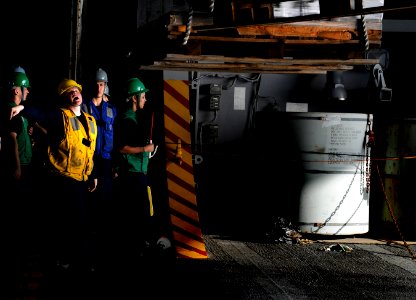 US Navy 110210-N-8040H-154 Boatswain's Mate 3rd Class Hillary Luke directs cargo in the hangar bay of USS Carl Vinson (CVN 70) during a replenishme photo