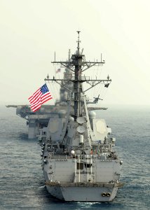 US Navy 110214-N-6692A-087 The Arleigh Burke-class guided-missile destroyer USS Stockdale (DDG 106) maneuvers behind the amphibious assault ship US
