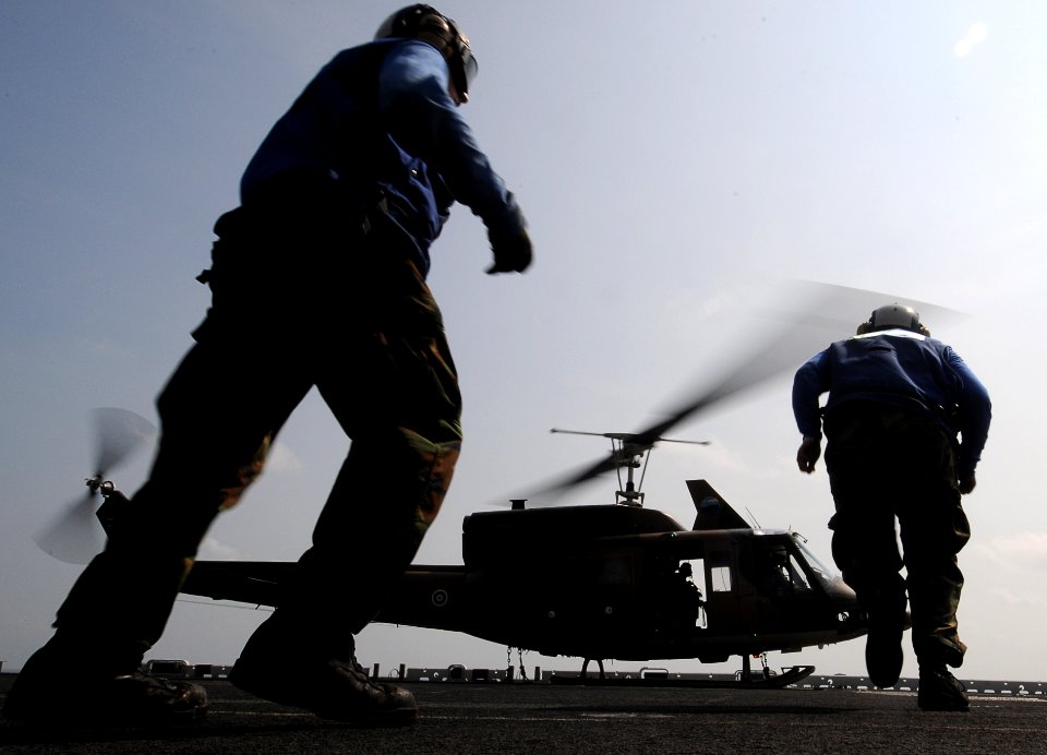 US Navy 110216-N-4743B-187 Sailors run out to chock and chain a Royal Thai Navy Bell 212 helicopter aboard USS Essex (LHD 2)