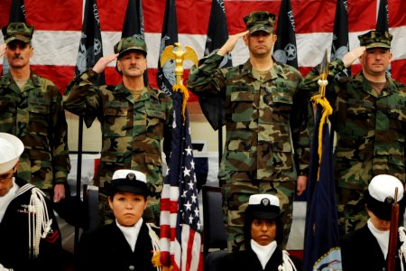 US Navy 110210-N-YO394-002 Rear Adm. Michael Tillotson and others salute during the national anthem at the beginning of the EODMU-12 change of comm photo