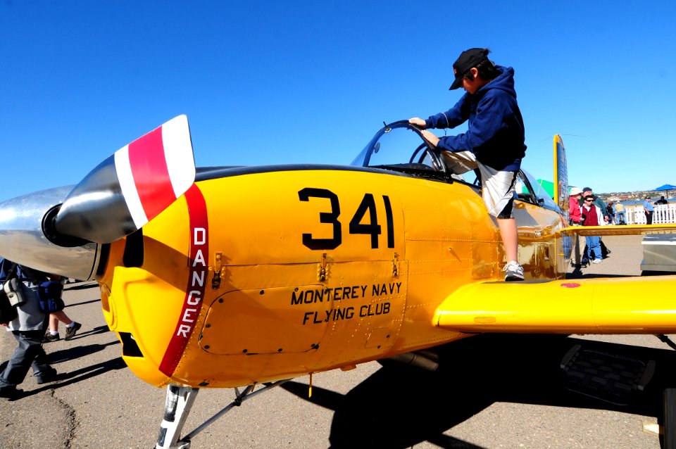 US Navy 110212-N-3659B-064 A child climbs out of the cockpit of a T-34B Mentor during the Centennial of Naval Aviation Open House and Parade of Fli