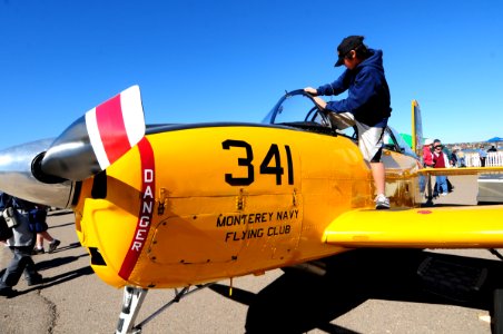 US Navy 110212-N-3659B-064 A child climbs out of the cockpit of a T-34B Mentor during the Centennial of Naval Aviation Open House and Parade of Fli photo