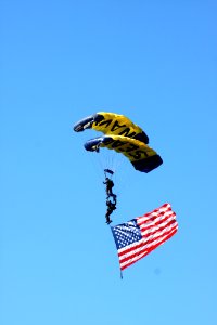 US Navy 110212-N-3446M-029 Sailors assigned to the U.S. Navy parachute demonstration team, the Leap Frogs, carry an American flag during a perform photo