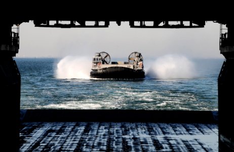 US Navy 110211-N-7508R-026 A landing craft air cushion (LCAC) assigned to Assault Craft Unit (ACU) 4 approaches the well deck of the multi-purpose photo