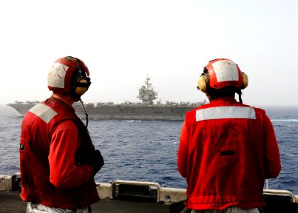 US Navy 110216-N-2908M-073 Sailors watch the aircraft carrier USS Enterprise (CVN 65) from aboard the amphibious assault ship USS Kearsarge (LHD 3)