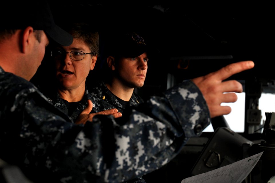 US Navy 110216-N-7293M-005 The bridge crew discuss navigation details