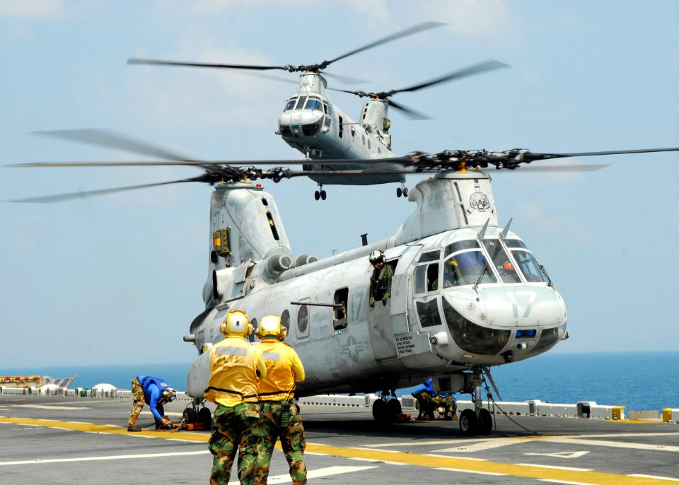 US Navy 110213-N-8607R-296 A CH-46E Sea Knight helicopter lands aboard the forward-deployed amphibious assault ship USS Essex (LHD 2)