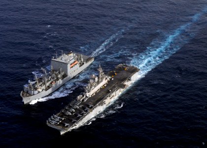 US Navy 110216-N-3154P-580 The amphibious assault ship USS Kearsarge (LHD 3), right, pulls alongside the Military Sealift Command dry cargo and amm