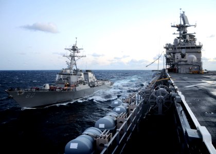 US Navy 110212-N-7508R-039 The guided-missile destroyer USS Roosevelt (DDG 80) prepares to receive a fuel hose from the multi-purpose amphibious as