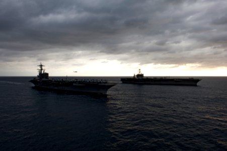 US Navy 110217-N-7317W-005 The aircraft carriers USS George H.W. Bush (CVN 77), front, and USS Harry S. Truman (CVN 75) conduct an ordnance transfe