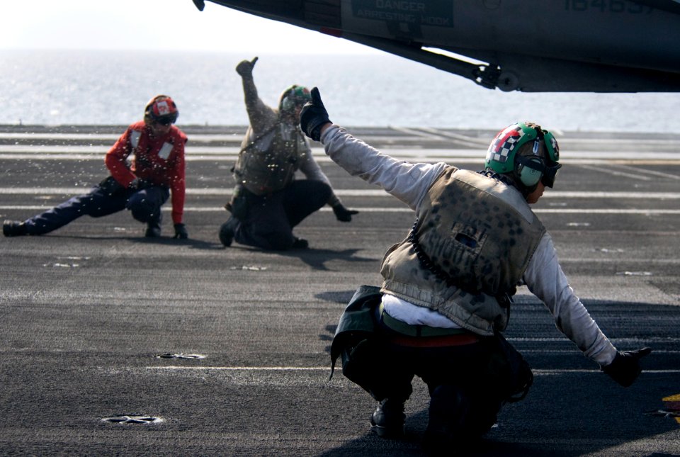 US Navy 110215-N-7488A-451 Sailors make final checks on an F-A-18E Super Hornet aboard USS Carl Vinson (CVN 70)