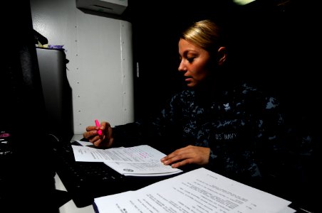 US Navy 110216-N-8040H-216 egalman 2nd Class Alahnna Taylor processes administrative paperwork in the flag administration office aboard USS Carl V