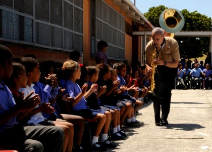 US Navy 110215-N-5085J-228 Musician 2nd Class Tony Carter, assigned to the U.S. Naval Forces Europe Brass Band, performs for children at the Buckro photo