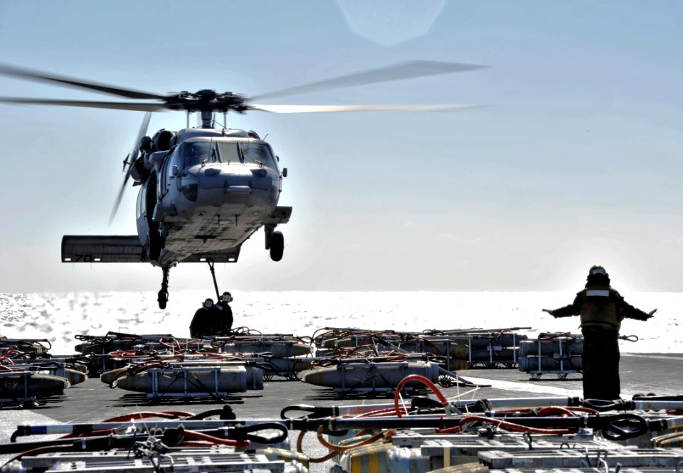 US Navy 110215-N-6003P-063 An MH-60S Sea Hawk helicopter assigned to the Chargers of Helicopter Sea Combat Squadron (HSC) 26 transfer ordnance