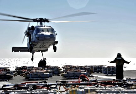 US Navy 110215-N-6003P-063 An MH-60S Sea Hawk helicopter assigned to the Chargers of Helicopter Sea Combat Squadron (HSC) 26 transfer ordnance