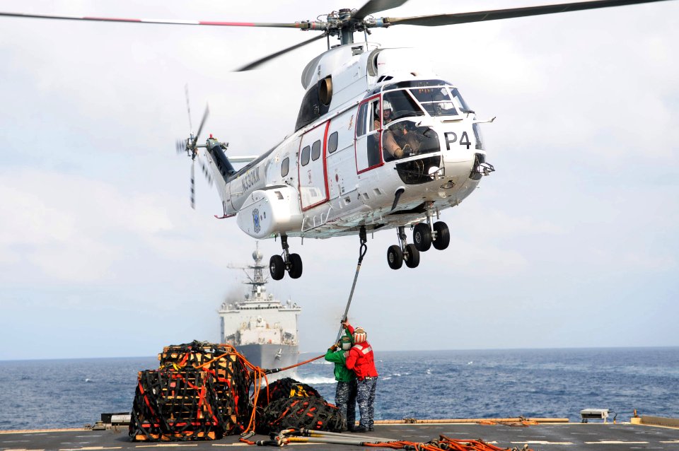 US Navy 110215-N-6692A-039 Sailors aboard the amphibious transport dock ship USS Denver (LPD 9) hook up a pole pendant to a SA-330J Puma helicopter
