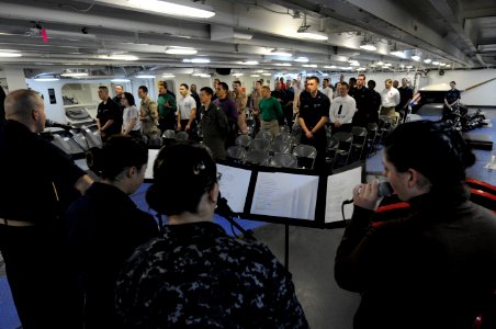 US Navy 110213-N-8040H-032 Sailors sing gospel hymns on the focisle during a non-denominational Christian service aboard the Nimitz-class aircraft