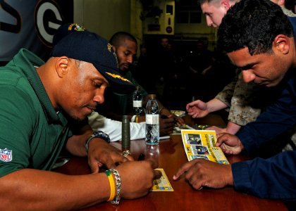 US Navy 110214-N-2908M-043 Super Bowl XLV champions, the Green Bay Packers, sign autographs for Sailors and Marines aboard the amphibious assault s