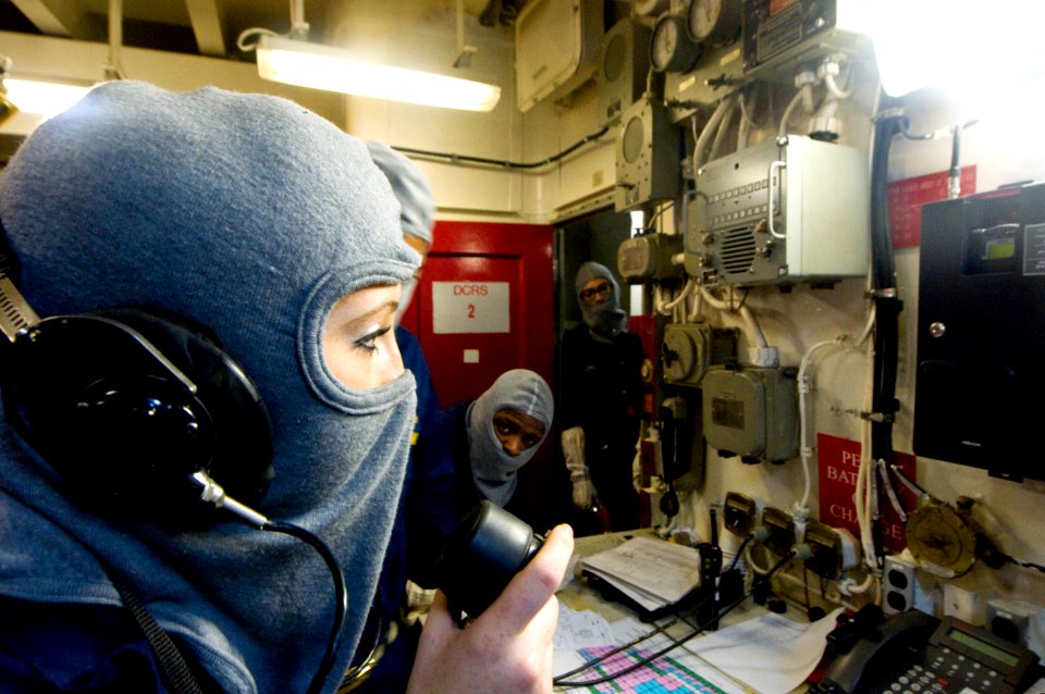 US Navy 110219-N-2953W-138 Hull Maintenance Technician Fireman Apprentice Amanda Mathis uses a sound-powered telephone to communicate with Damage C