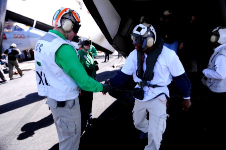 US Navy 110216-N-2055M-049 Cmdr. Putnam Browne greets the Green Bay Packers Cornerback and Safety, Jarret Bush, during a visit aboard USS Carl Vins