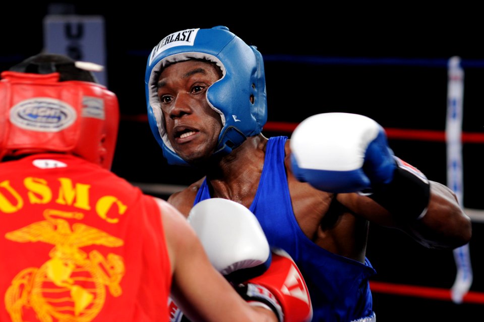 US Navy 110216-N-2610F-271 Ship's Serviceman Seaman Keston Williams, right, and Lance Cpl. Tommy Roque compete in the 132 lb. weight class during t