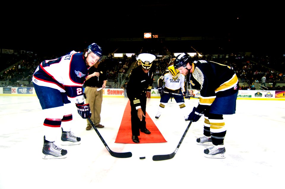 US Navy 110218-N-5328N-713 Cmdr. Michael Douglas drops the ceremonial puck for the Feb. 18 game between the Pensacola Ice Flyers (right) and the Au
