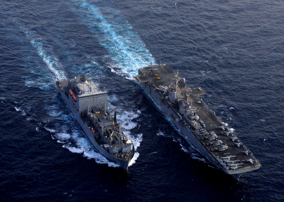 US Navy 110216-N-3154P-624 The amphibious assault ship USS Kearsarge (LHD 3), right, pulls alongside the Military Sealift Command dry cargo and amm