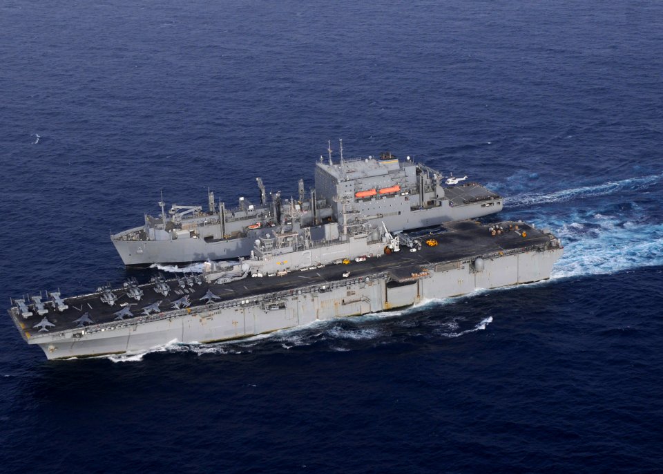 US Navy 110216-N-3154P-721 The amphibious assault ship USS Kearsarge (LHD 3), bottom, pulls alongside the Military Sealift Command dry cargo and am