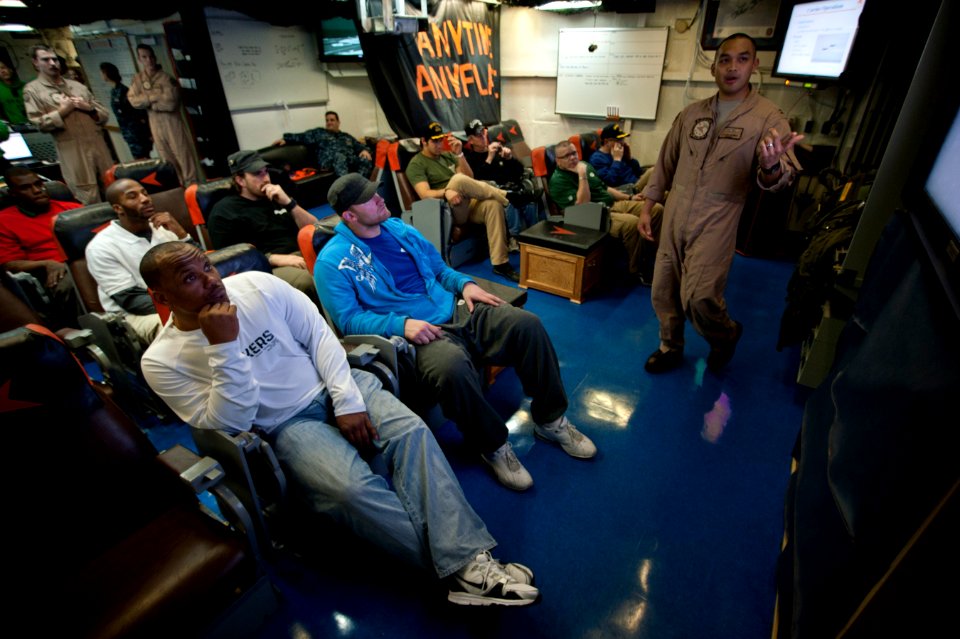 US Navy 110216-N-DR144-080 Members of the Green Bay Packers football team listen as Lt. Christopher Viernes gives a presentation about Strike Fight