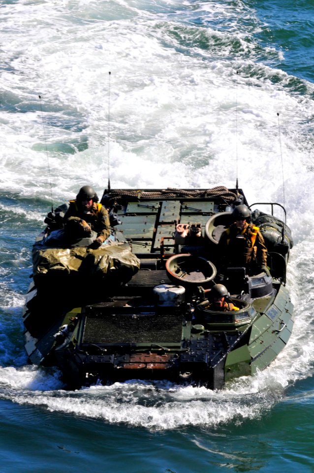 US Navy 110222-N-7042V-067 Amphibious assault vehicles transporting marines and supplies approach the well deck of the amphibious transport dock sh