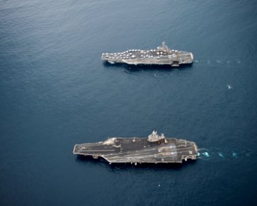 US Navy 110217-N-7317W-051 The aircraft carriers USS Harry S. Truman (CVN 75), front, and USS George H.W. Bush (CVN 77) conduct an ordnance transfe
