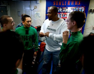 US Navy 110216-N-DR144-168 William Henderson, a fullback for the Green Bay Packers football team, shows his Super Bowl championship ring to Sailors