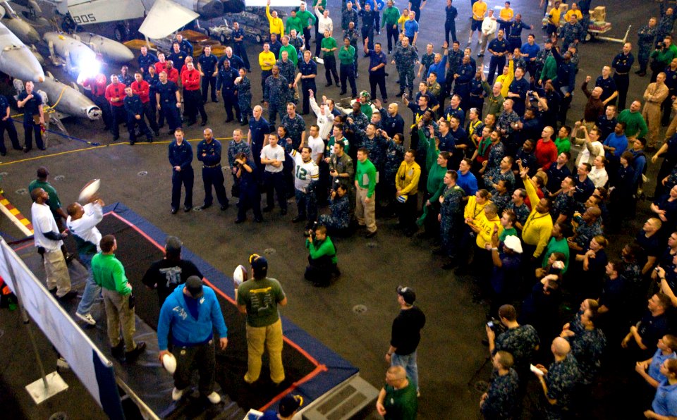 US Navy 110216-N-2953W-018 Members of the Green Bay Packers football team throw footballs to Sailors aboard the aircraft carrier USS Carl Vinson (C