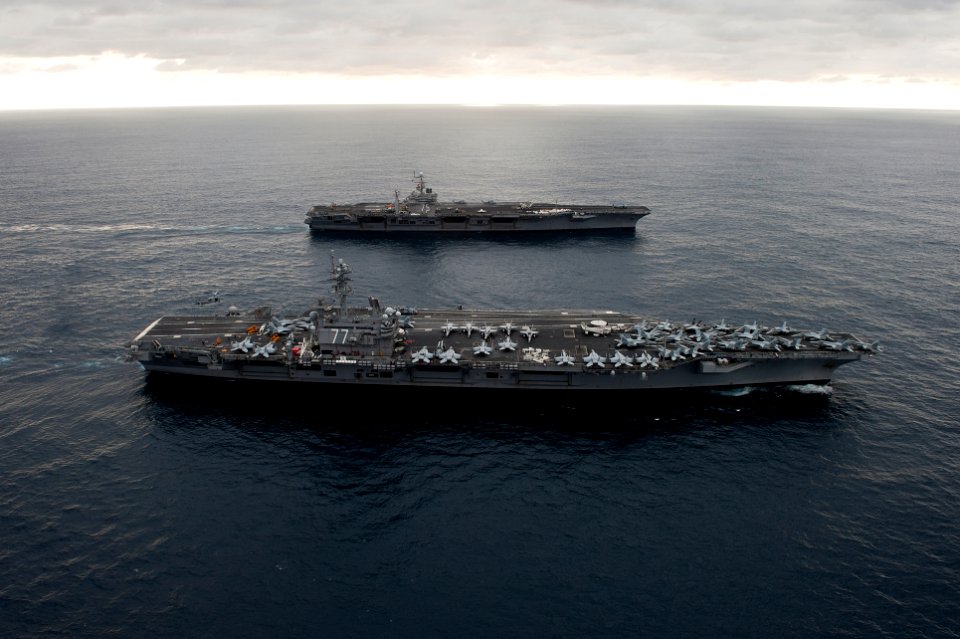 US Navy 110217-N-7317W-018 The aircraft carriers USS George H.W. Bush (CVN 77), front, and USS Harry S. Truman (CVN 75) conduct an ordnance transfe