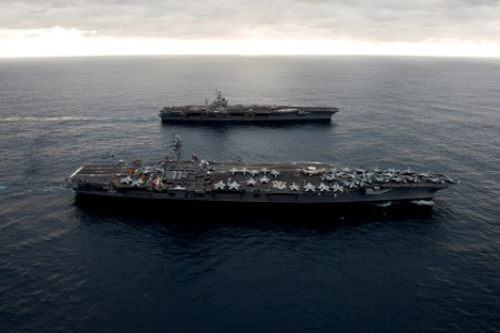 US Navy 110217-N-7317W-018 The aircraft carriers USS George H.W. Bush (CVN 77), front, and USS Harry S. Truman (CVN 75) conduct an ordnance transfe