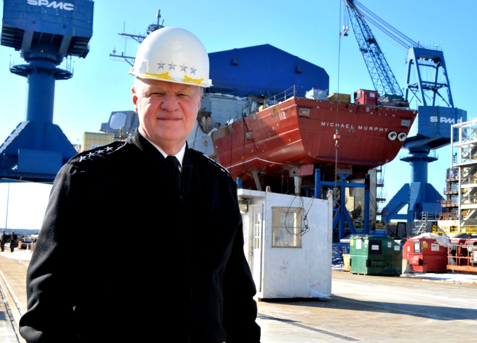 US Navy 110223-N-ZB612-014 Chief of Naval Operations (CNO) Adm. Gary Roughead poses for a photograph with the keel of the future guided-missile des