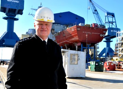 US Navy 110223-N-ZB612-014 Chief of Naval Operations (CNO) Adm. Gary Roughead poses for a photograph with the keel of the future guided-missile des