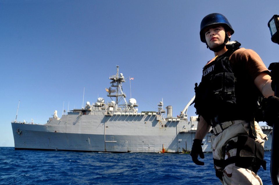 US Navy 110218-N-7293M-037 Electronics Technician 2nd Class Jose Lopez-Davila rides an 11-meter rigid-hull inflatable boat from the amphibious tran