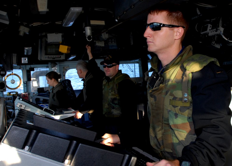 US Navy 110218-N-2686K-023 Ensign Jesse M. Duparc, right, an auxiliary officer aboard the guided-missile cruiser USS Gettysburg (CG 64), stands wat