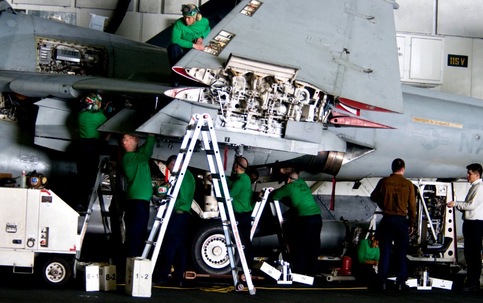 US Navy 110218-N-7488A-095 Sailors assigned to Electronic Attack Squadron (VAQ) 134 perform maintenance on an EA-6B Prowler in the hangar bay aboar