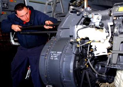 US Navy 110218-N-KF029-035 Aviation Ordnanceman 2nd Class Andrew Marton, from Reno, Nev., conducts maintenance on an M61A2 gun system in the hangar