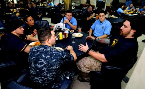US Navy 110217-N-8040H-402 Darryn Colledge, an offensive guard for the Green Bay Packers, speaks with Sailors aboard the Nimitz-class aircraft carr