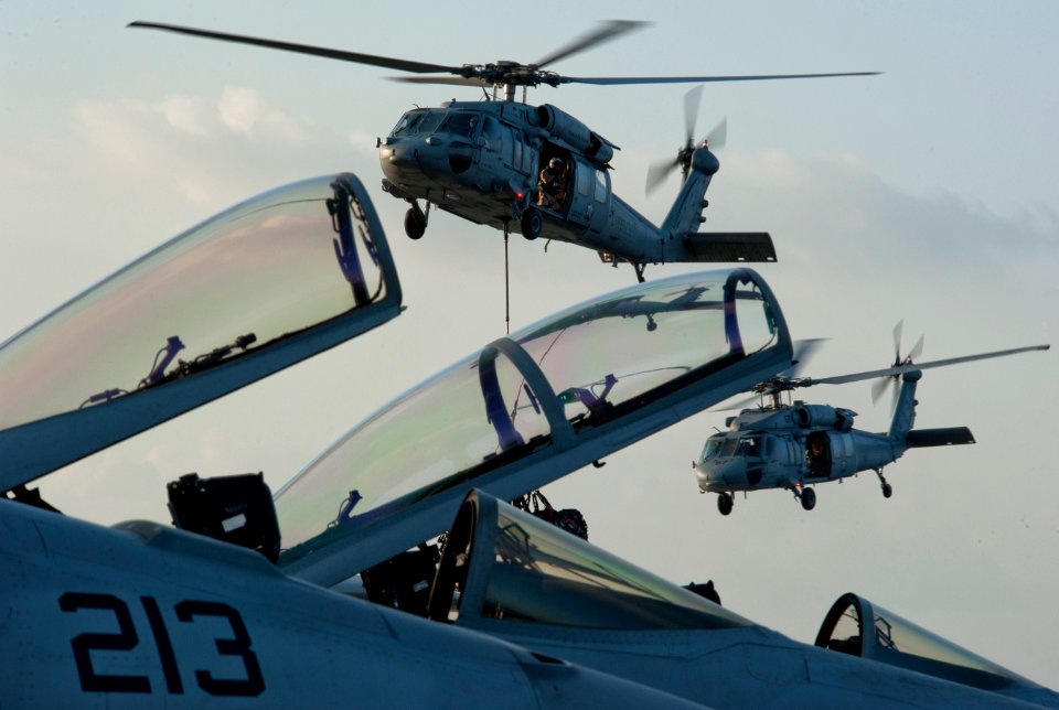 US Navy 110217-N-DR144-129 MH-60 Sea Hawk helicopters assigned to the Blackjacks of Helicopter Sea Combat Squadron (HSC) 21 deliver stores to the N