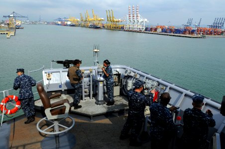 US Navy 110221-N-6692A-090 Sailors stand watch on the port bridge wing aboard the amphibious dock landing ship USS Germantown (LSD 42) as the ship